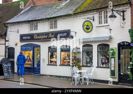 couple man and woman looking in through the window of a jewellers shop in the warwickshire market town of Stratford upon Avon Stock Photo