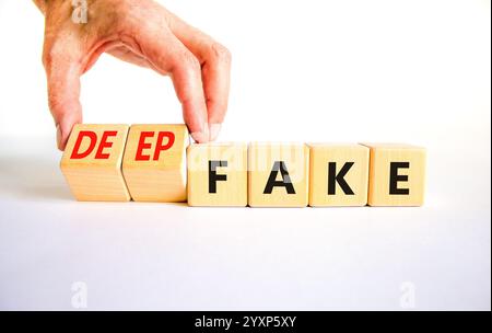 Deepfake or fake symbol. Concept words Fake Deepfake on wooden cubes. Beautiful white table white background. Businessman hand. Business and deepfake Stock Photo