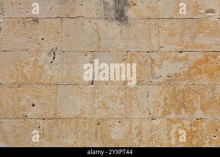 Wall of white and gray adarce travertine stone brick blocks, close up background texture, side view Stock Photo
