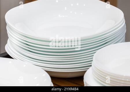 Many white different plates stacked together in restaurant Stock Photo