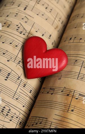 Heart figure on musical note sheets, closeup Stock Photo