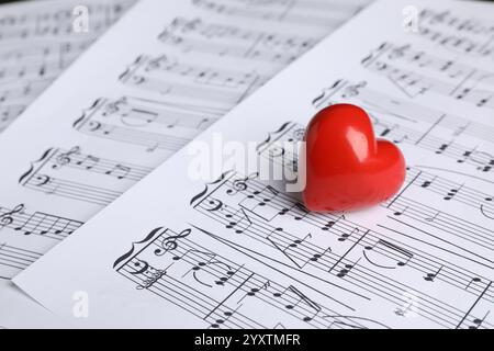 Heart figure on musical note sheets, closeup Stock Photo