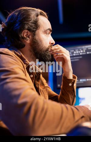 Software Developer Carefully Writing Code On Laptop In Cloud-based ...