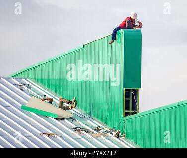 A worker fell while working on the roof of the hall Stock Photo