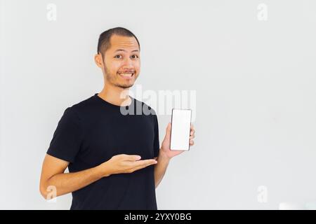 Men showing blank screen smartphone with black empty shirt on isolated white background Stock Photo