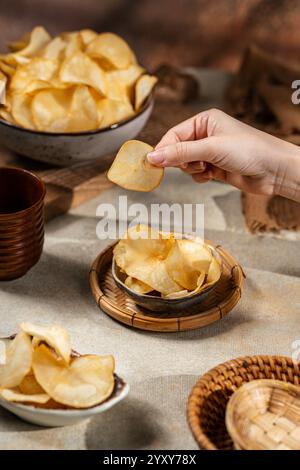 Cassava chips, a traditional Indonesian snack, are made from thin slices of cassava and then dry fried sprinkled with salt Stock Photo