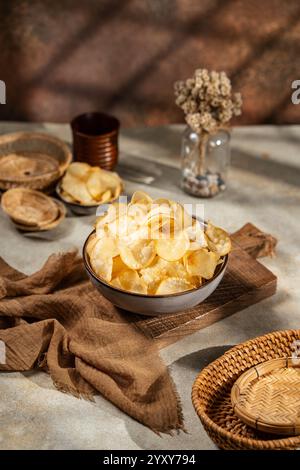 Cassava chips, a traditional Indonesian snack, are made from thin slices of cassava and then dry fried sprinkled with salt Stock Photo