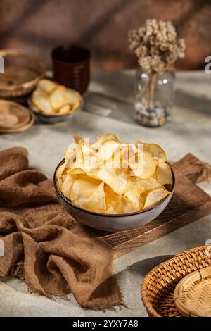 Cassava chips, a traditional Indonesian snack, are made from thin slices of cassava and then dry fried sprinkled with salt Stock Photo