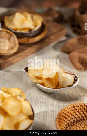 Cassava chips, a traditional Indonesian snack, are made from thin slices of cassava and then dry fried sprinkled with salt Stock Photo