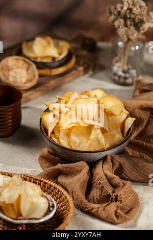 Cassava chips, a traditional Indonesian snack, are made from thin slices of cassava and then dry fried sprinkled with salt Stock Photo