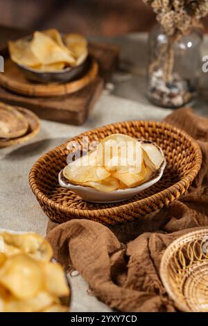 Cassava chips, a traditional Indonesian snack, are made from thin slices of cassava and then dry fried sprinkled with salt Stock Photo