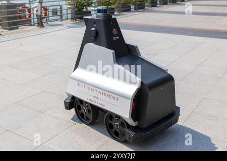 The Fullerton Hotel automatic street cleaner moves along the pavement by the waterfront, Singapore, Photo: David Rowland / One-Image.com Stock Photo