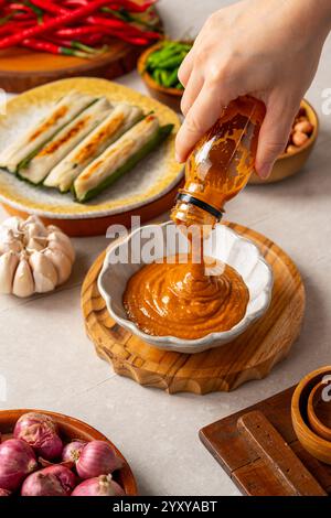 Otak-otak is a Southeast Asian fish cake made of ground fish meat mixed with spices and wrapped into leaf parcels. Stock Photo