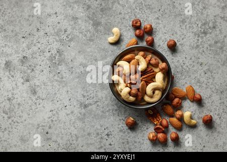 bowl of various nuts on grey table, top view Stock Photo