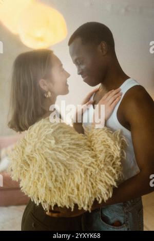Romantic smiling multiracial young couple dancing with each other at home Stock Photo