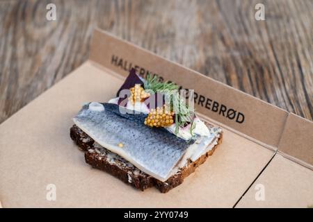 Contemporary Smørrebrød of pickled herring on rye bread in Copenhagen, Denmark Stock Photo