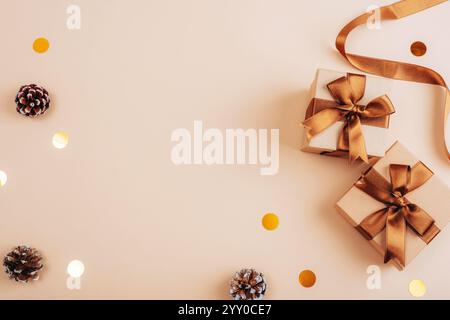 Golden gift boxes with ribbons and pine cones. Top view, flat lay, copy space. Stock Photo