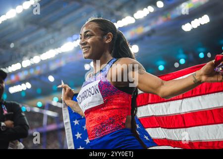 Sha'Carri Richardson celebrating her medal with her country's flag at the Paris 2024 Olympic Games. Stock Photo