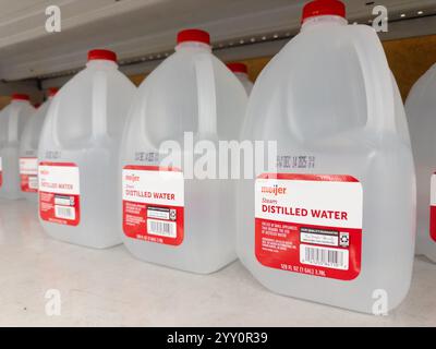 Plastic gallon jugs of distilled water on a shelf at a Meijer super center store in Michigan USA Stock Photo