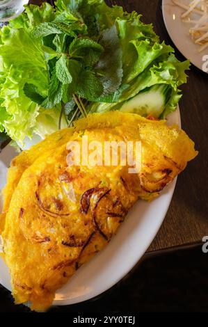Vietnamese Banh Xeo Crispy Pancake with Fresh Herbs and Lettuce Stock Photo