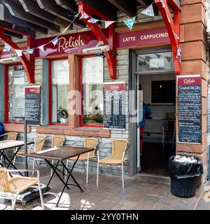 Exterior view of Relish cafe, Keswick, with tables and chairs on the pavement, and menu boards on the walls Stock Photo