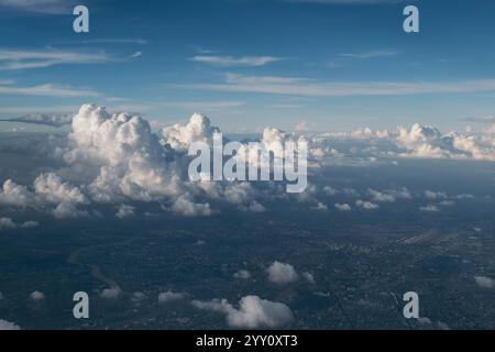 cityscape view from airplane with cloudy blue sky above, photo may has some noise Stock Photo