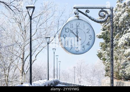 Vintage street clock in winter. New Year time.. Stock Photo