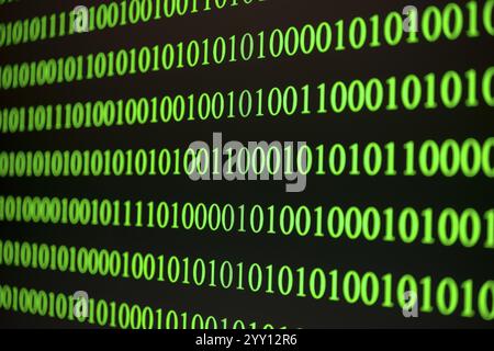 Green binary numbers in a row, symbolising digital technology Stock Photo