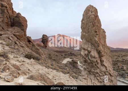 Panorama at sunrise on the Roque Chinchado, also known as the Stone Tree or Finger of God, landmark of the island, Los Roques de Garcia, behind it the Stock Photo