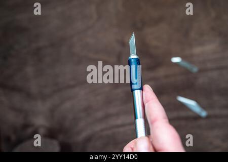 utility knife (also known as precision or exacto knife) with interchangeable blades used for crafting or modelmaking Stock Photo