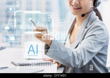 Business woman pointing on futuristic AI assistant virtual screen while working in modern office Stock Photo