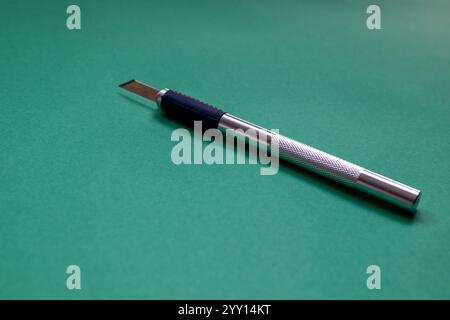 utility knife (also known as precision or exacto knife) with interchangeable blades used for crafting or modelmaking Stock Photo