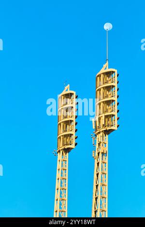 Construction Cranes and Moon Against Blue Sky Aerial Stock Photo