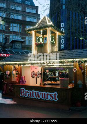 Bratwurst stall and lights at  the Christmas fair in Leicester Square, London Stock Photo