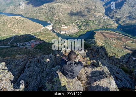 unidentified man with his back turned observing a mountain landscape in the Douro region of Portugal. Stock Photo