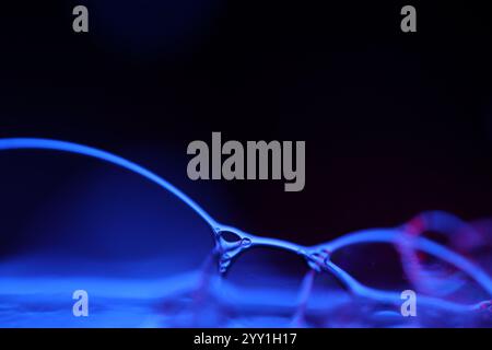 Blue fantastic reflections on black background, liquid abstraction, colour waves, deep dark backgrounds Stock Photo