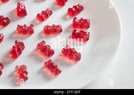Group of red jelly gummy bears  on a white background. Tasty jelly candies. Stock Photo