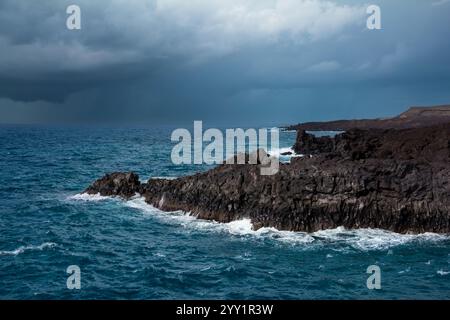 Rugged Volcanic Coastline with Crashing Waves at Los Hervideros, Lanzarote, Canary Islands, Spain Stock Photo
