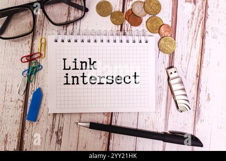 Link intersect business seo concept text on a white notebook and hourglass clock, green leaves of flowers Stock Photo