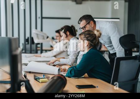 Multicultural team collaborating on a project in modern office Stock Photo
