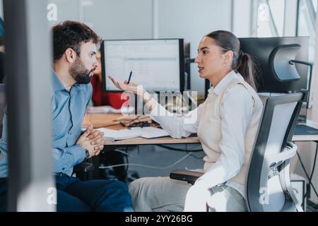 Professional discussion between two colleagues in modern office environment Stock Photo