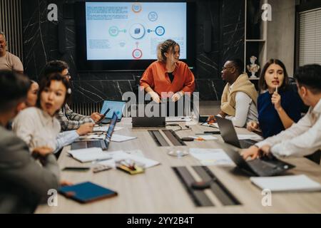 Diverse business team collaborates on project ideas in modern office setting Stock Photo