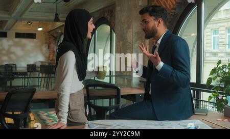 Male female Indian Muslim woman man businessman businesswoman business partners girl guy office architects engineers designers builders discuss Stock Photo