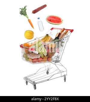 Groceries falling into shopping cart on white background Stock Photo