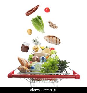 Groceries falling into shopping cart on white background Stock Photo