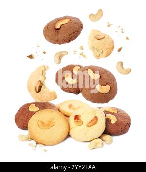 Tasty cookies with cashew nuts falling on white background Stock Photo