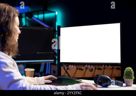 Freelancing admin using isolated screen computer monitors to filter malicious traffic from cybercriminals attempting to corrupt company data. IT specialist in apartment working on mockup desktop PC Stock Photo