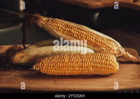 Raw corn on cutting board Stock Photo