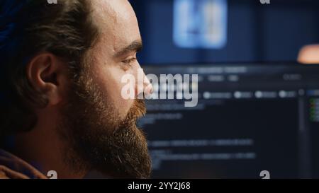 Happy software engineer feeling satisfied after removing all bugs while coding on computer, close up. Joyous IT admin looking at PC screen, pleased after solving script errors, camera A close up Stock Photo