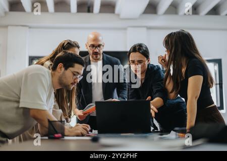 Students collaborating on a project guided by their supportive professor Stock Photo